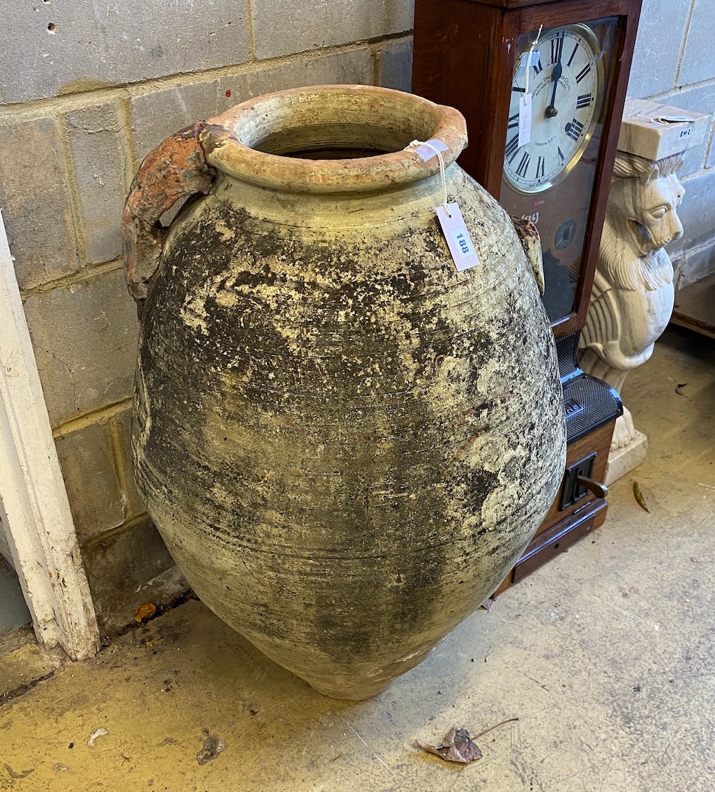 A terracotta amphora oil jar (a.f.), height 92cm